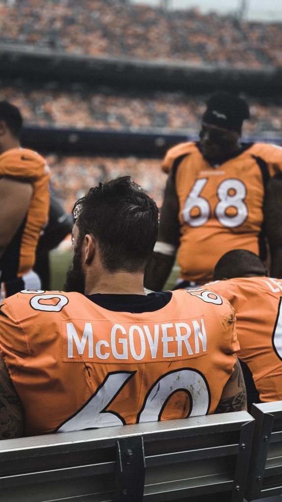 man in orange jersey shirt