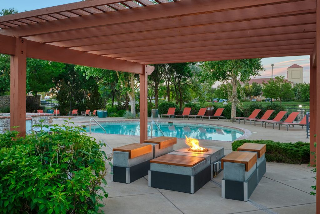 Poolside lounge area with a fire pit at Gateway Park Apartments in Denver, Colorado