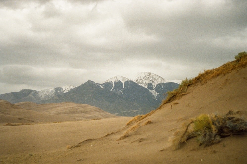 brown and green mountains under white clouds during daytime